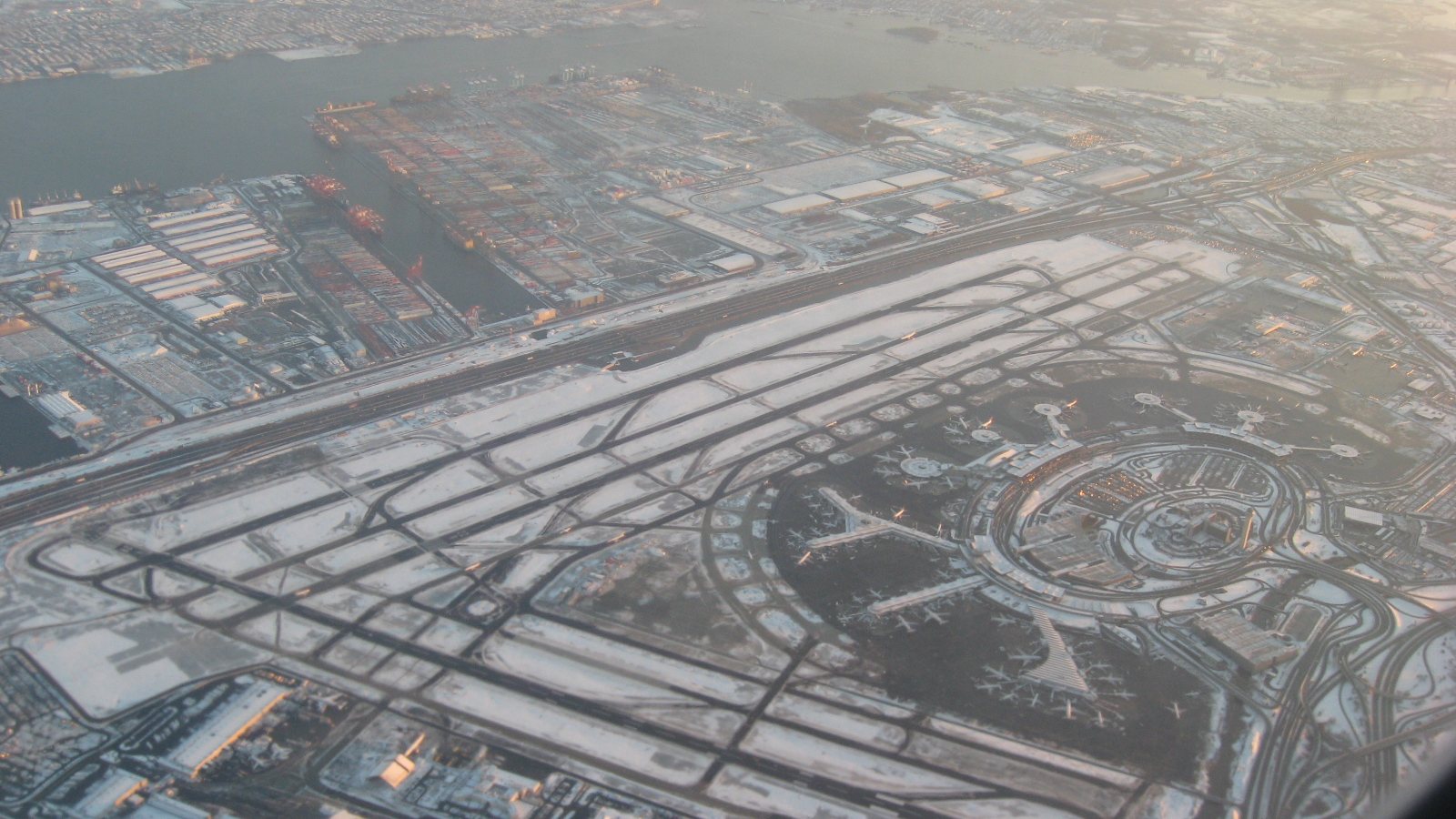 Aerial view of Newark Liberty airport with runways, terminals and the container port in winter